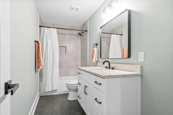 a view of a patio with table and chairs a barbeque with potted plants and large tree
