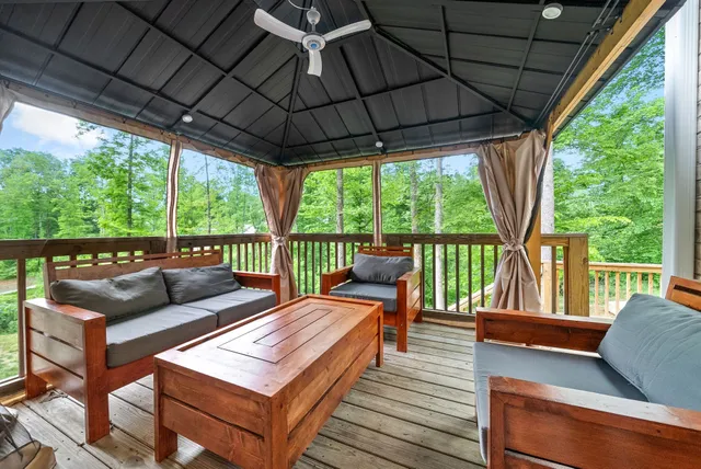an aerial view of residential house with outdoor space and trees all around