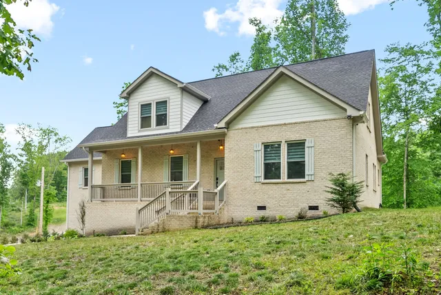 a front view of house with yard and green space