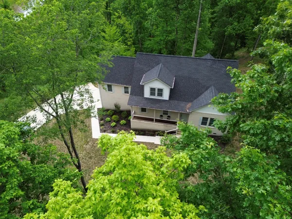 an aerial view of a house with a yard
