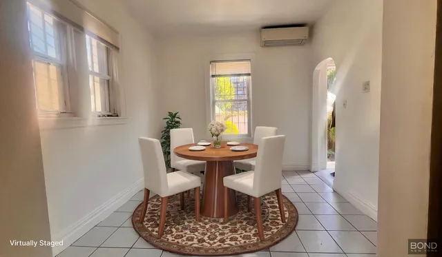 a dining room with furniture and window