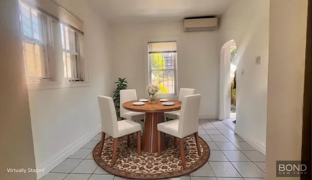 a dining room with furniture and window