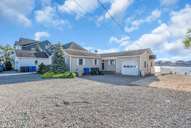 a front view of a house with a yard and a garage