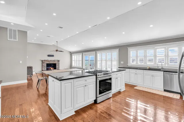 a kitchen with a stove a sink and a refrigerator