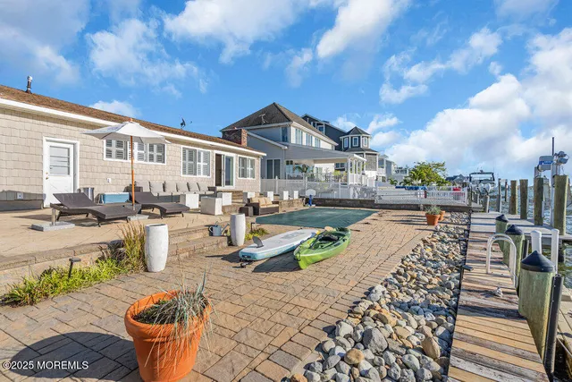 a front view of a house with swimming pool and sitting area