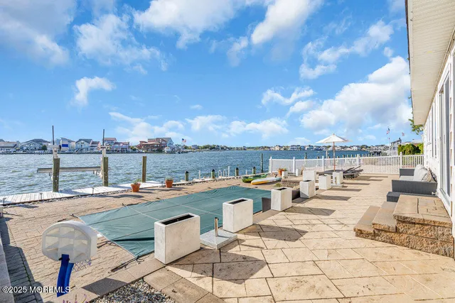 a view of a terrace with lawn chairs