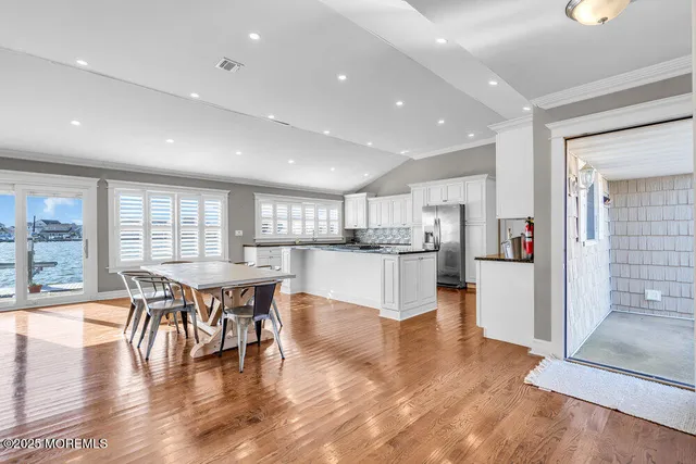 a open kitchen with white cabinets and stainless steel appliances