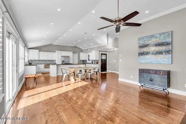 a living room with stainless steel appliances kitchen island granite countertop furniture and a kitchen view