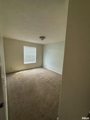 a view of an empty room and a window
