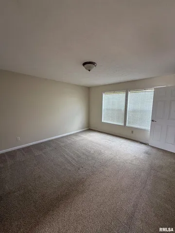 an empty room with a empty space and windows