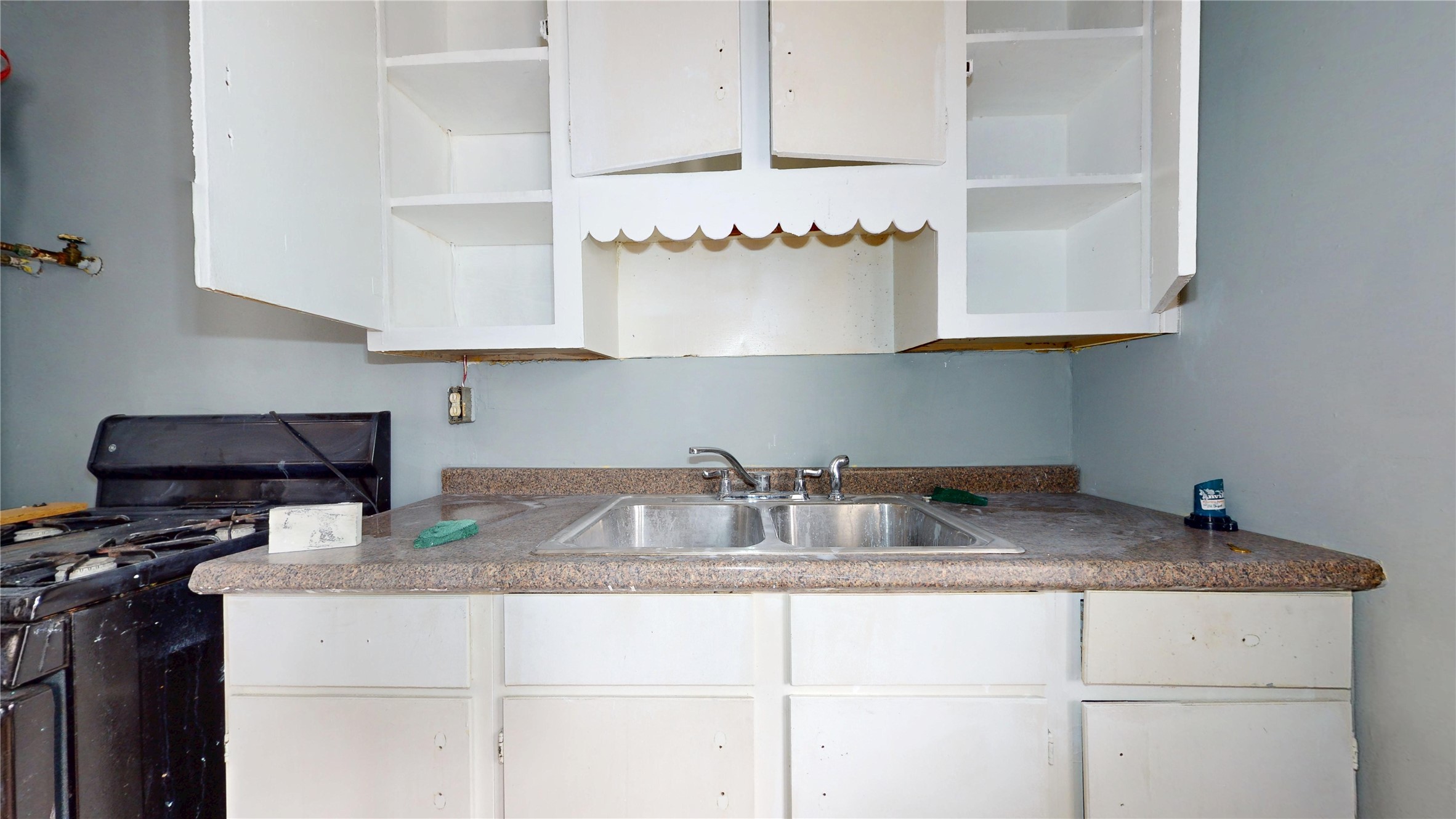 6604 Conley Street Houston, TX 77021 - Photo 15 of 28 a kitchen with granite countertop a sink and a stove