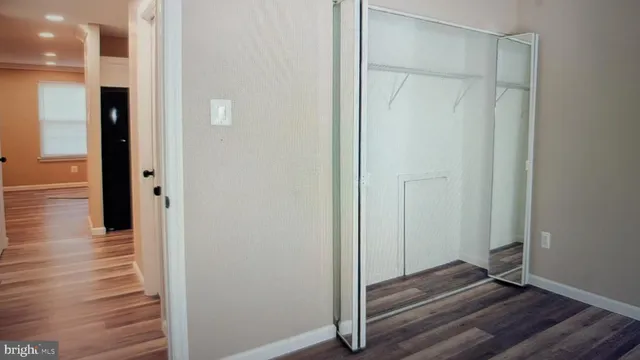 a view of a hallway with wooden floor