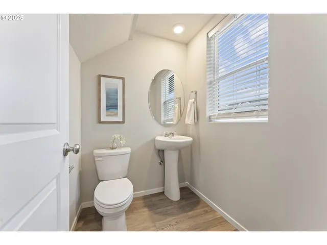 a bathroom with a toilet a sink and mirror