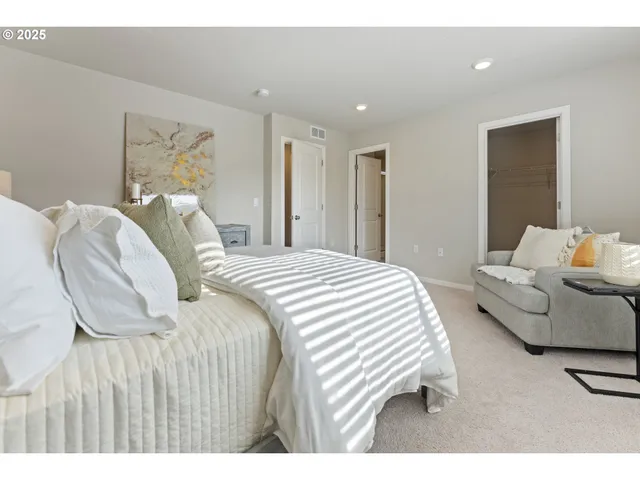 a bedroom with a bed and a couch