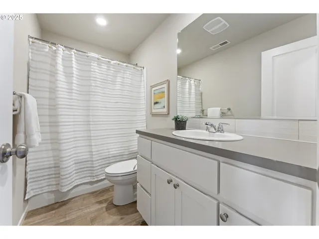 a bathroom with a sink a toilet and mirror