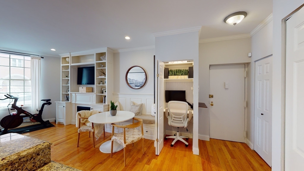 27 Bowdoin Street, Unit 1B Boston, MA 02114 - Photo 11 of 18 a living room with furniture and a wooden floor
