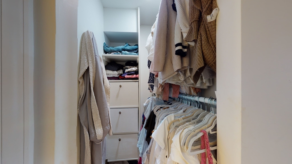 27 Bowdoin Street, Unit 1B Boston, MA 02114 - Photo 14 of 18 a view of walk in closet with clothes and shoes