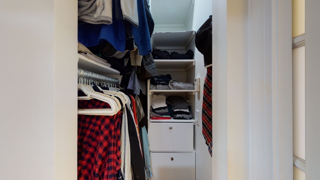27 Bowdoin Street, Unit 1B Boston, MA 02114 - Photo 15 of 18 a view of walk in closet with clothes and shoes