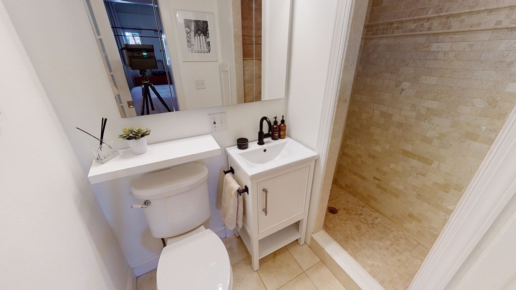 27 Bowdoin Street, Unit 1B Boston, MA 02114 - Photo 18 of 18 a white toilet sitting next to a bathroom sink