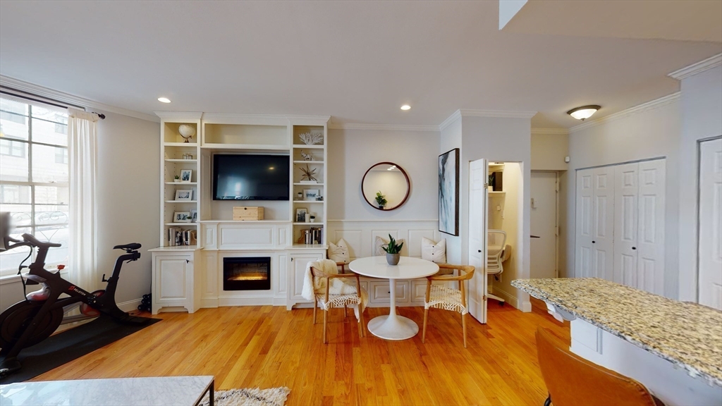 27 Bowdoin Street, Unit 1B Boston, MA 02114 - Photo 9 of 18 a living room with a flat screen tv and a fireplace