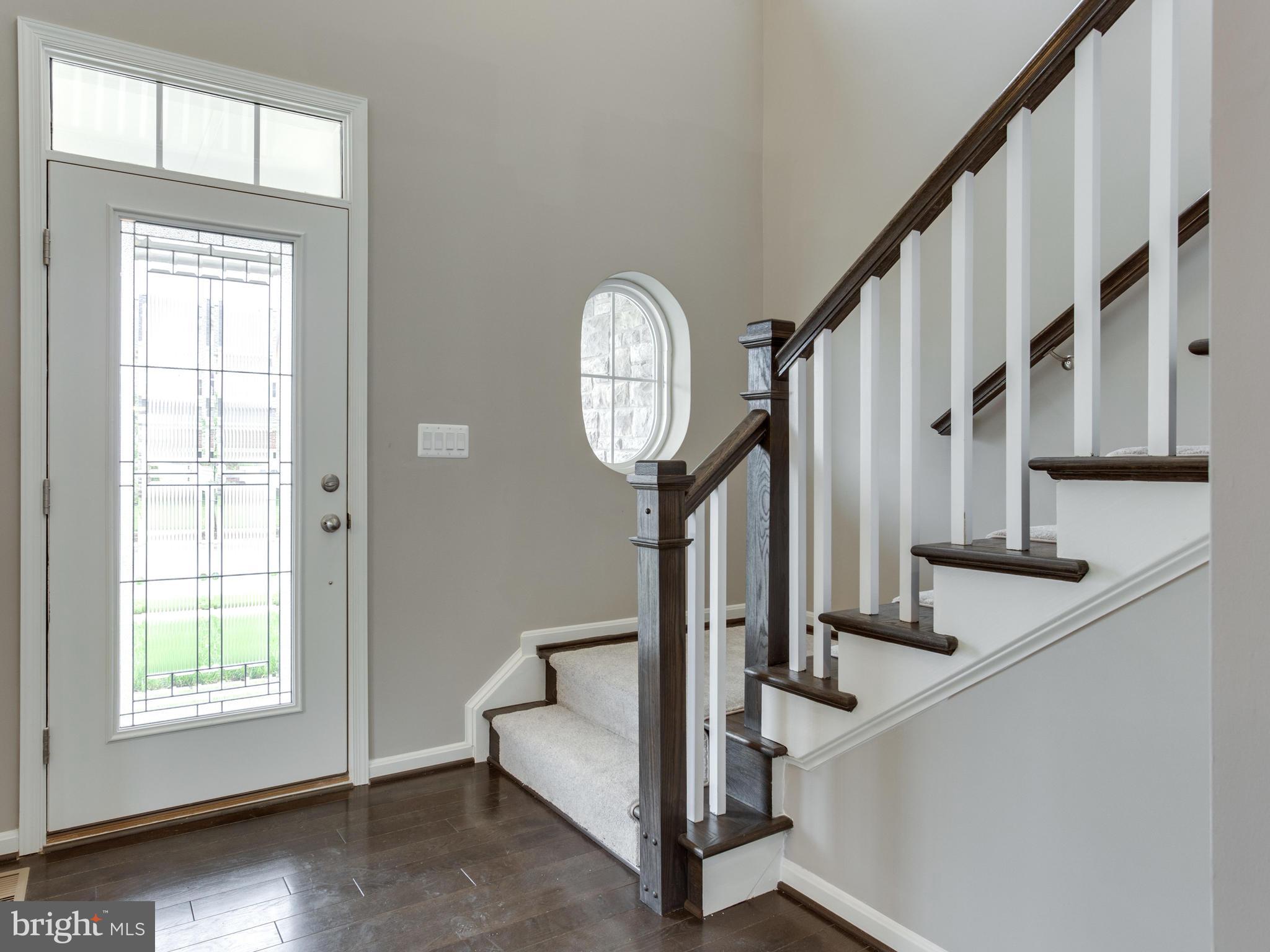 735 Holden Road Frederick, MD 21701 - Photo 3 of 30 a view of staircase with lots of frames and a window