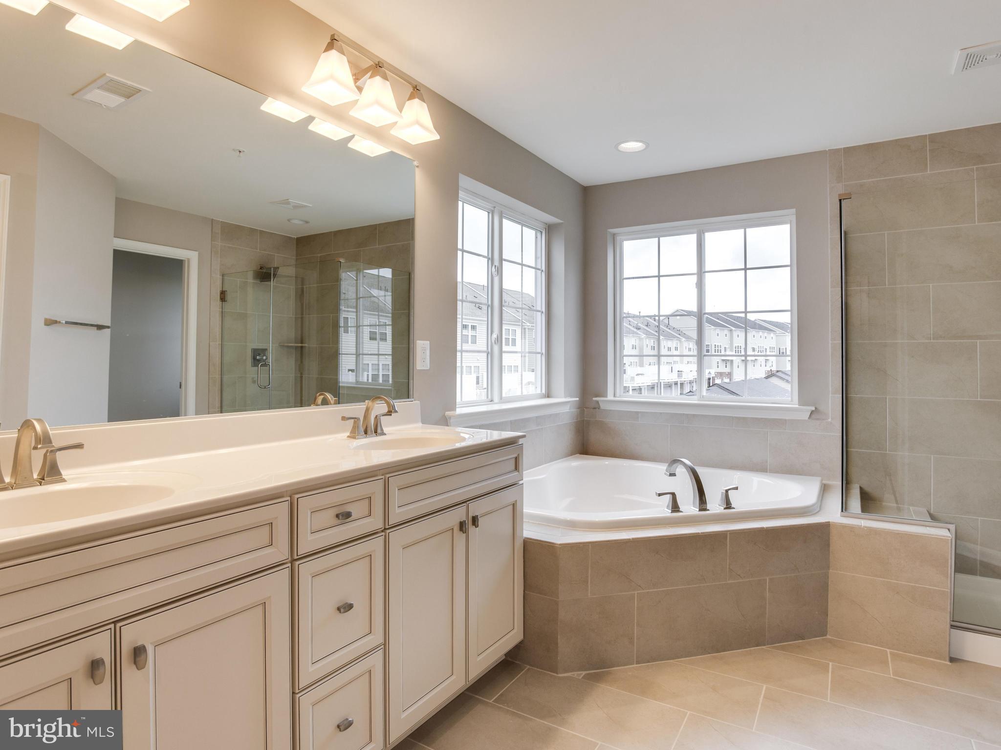 735 Holden Road Frederick, MD 21701 - Photo 22 of 30 a spacious bathroom with sink double vanity shower and a bathtub