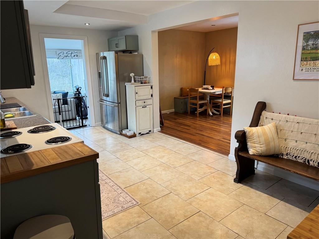 The kitchen is well equipped and has a nice spot for a eat-in table or a kick your shoes and hang you coat here spot.