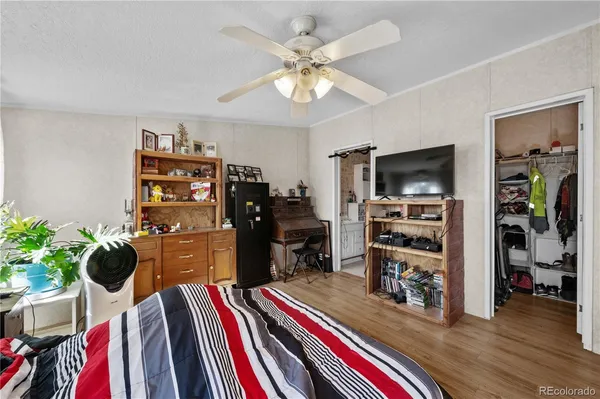 a bedroom with furniture and a flat screen tv