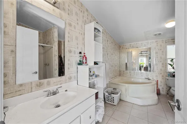 a bathroom with a double vanity sink mirror and toilet