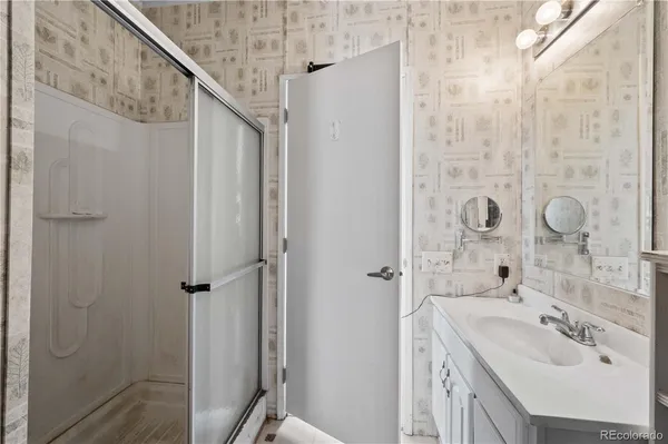 a bathroom with a sink a mirror and shower