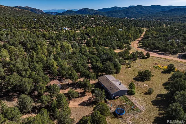 an aerial view of a house and mountain view
