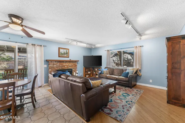 a living room with furniture a flat screen tv and a fireplace