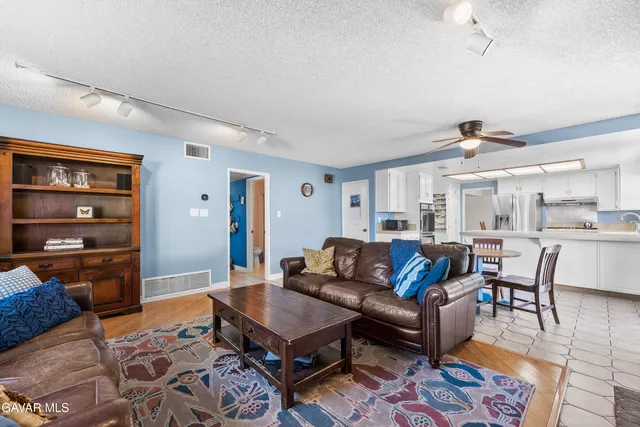 a bathroom with a toilet a sink a mirror and vanity