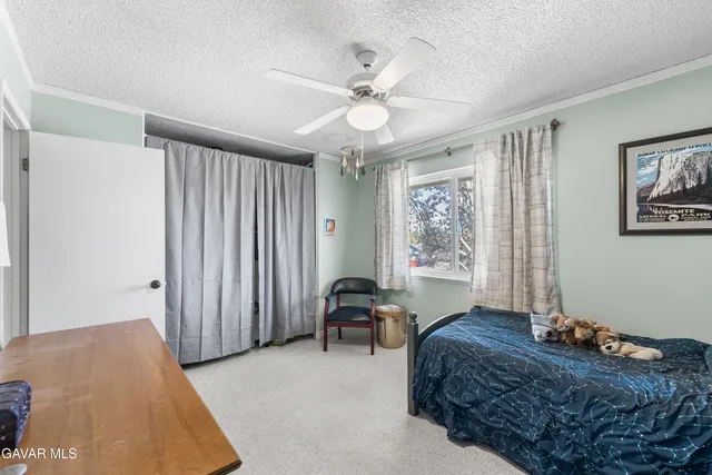 a bedroom with a bed couch and a window