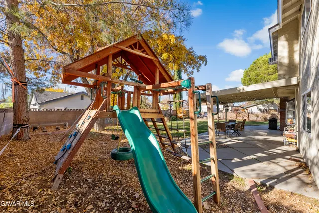 a front view of a house with a yard table and chairs