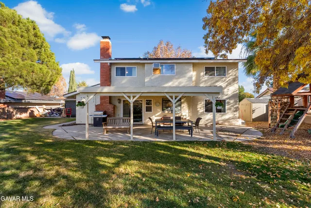 a front view of house with yard and outdoor seating