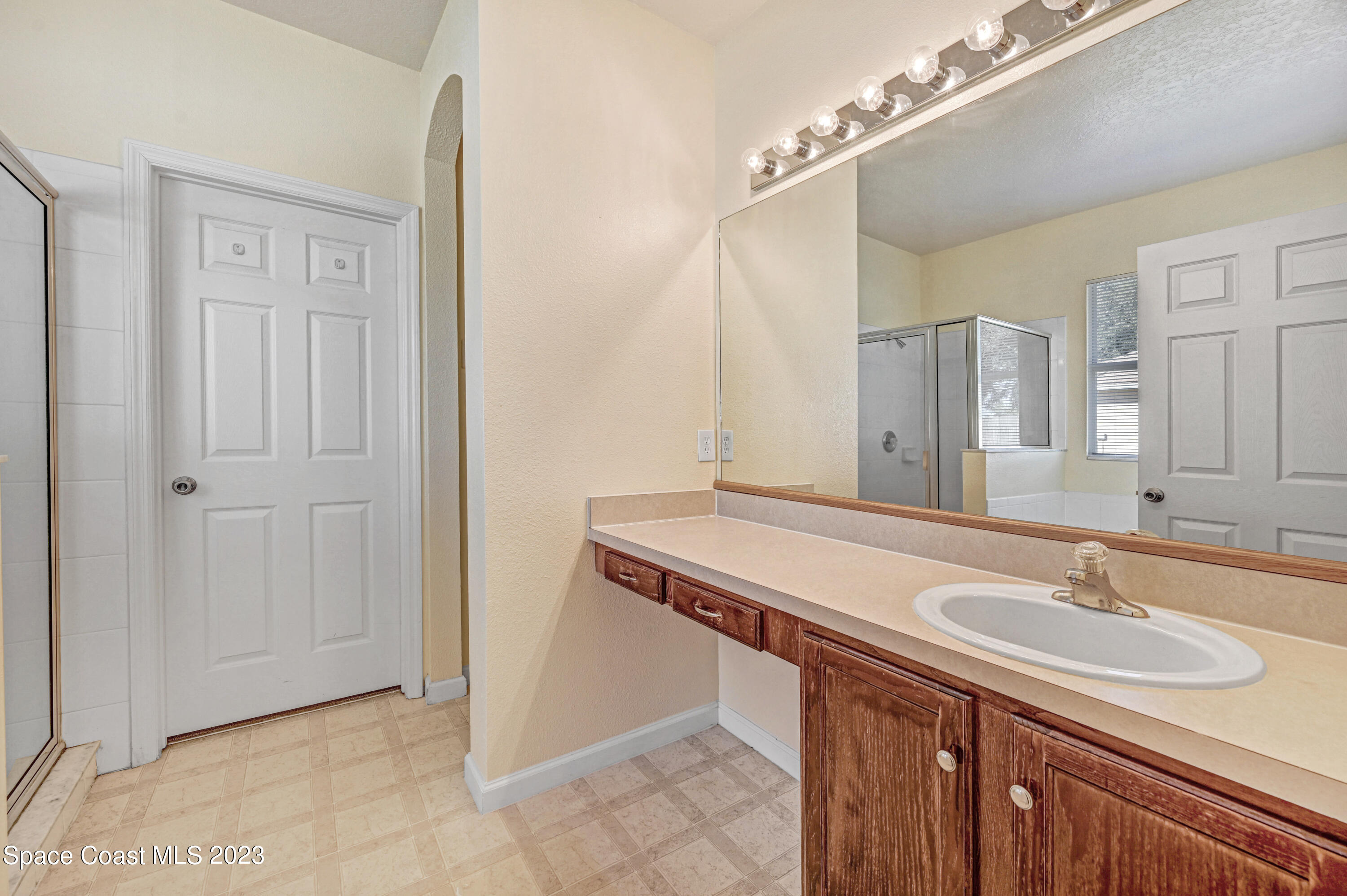 6720 Cairo Road Port St. John, FL 32927 - Photo 11 of 38 a bathroom with a sink and a mirror
