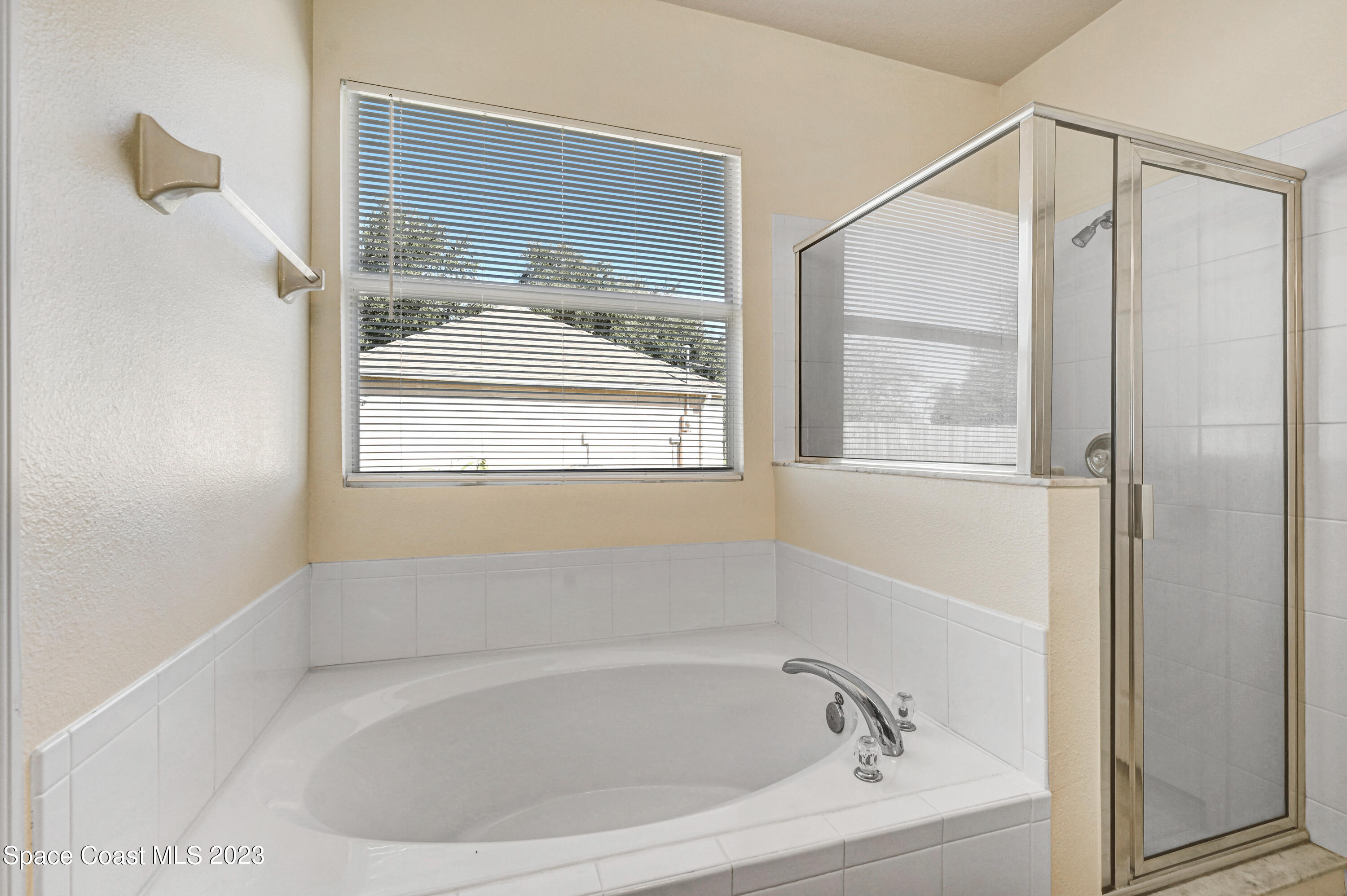 6720 Cairo Road Port St. John, FL 32927 - Photo 12 of 38 a white bath tub sitting next to a shower
