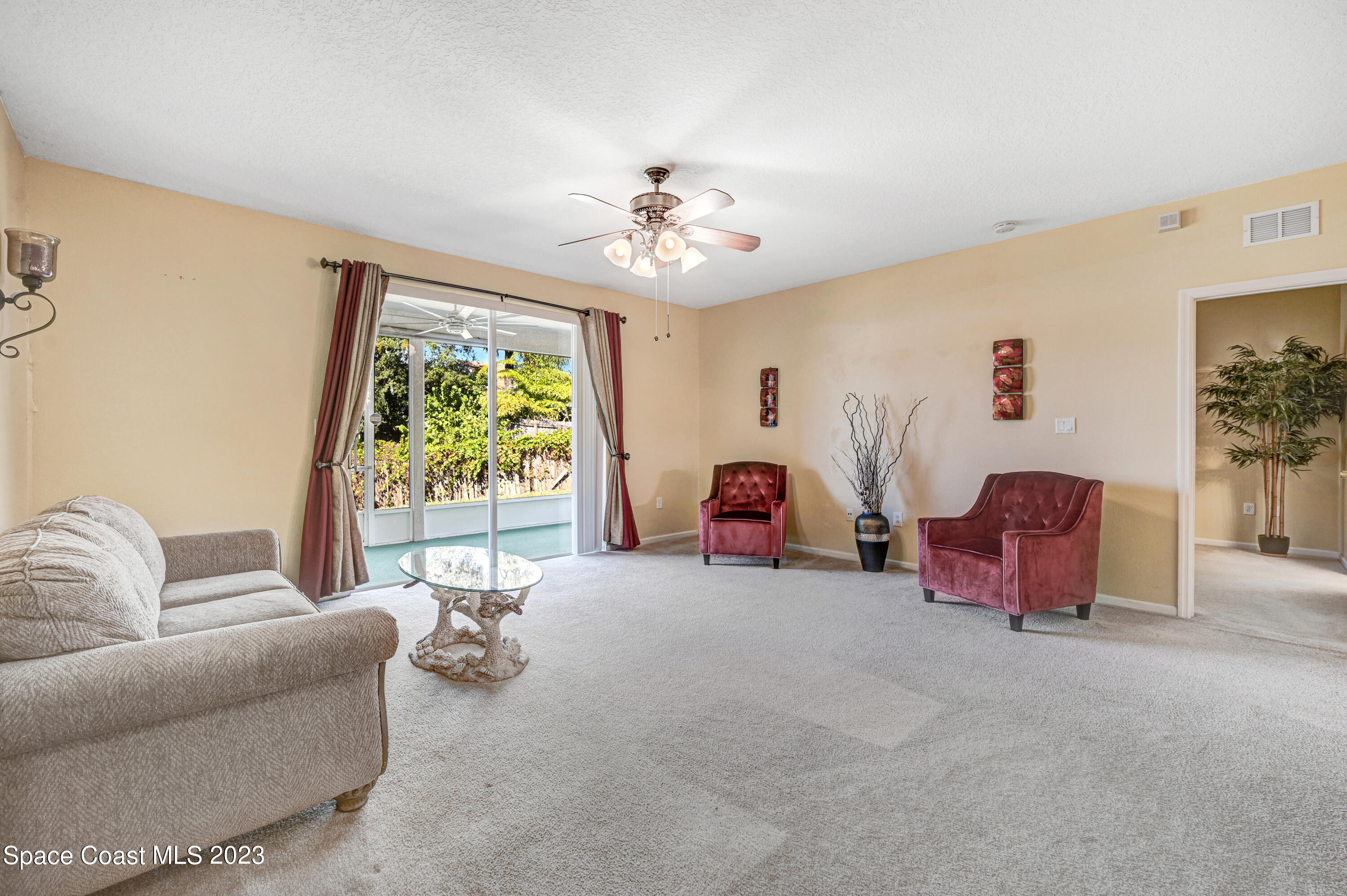 6720 Cairo Road Port St. John, FL 32927 - Photo 31 of 38 a living room with furniture and a large window