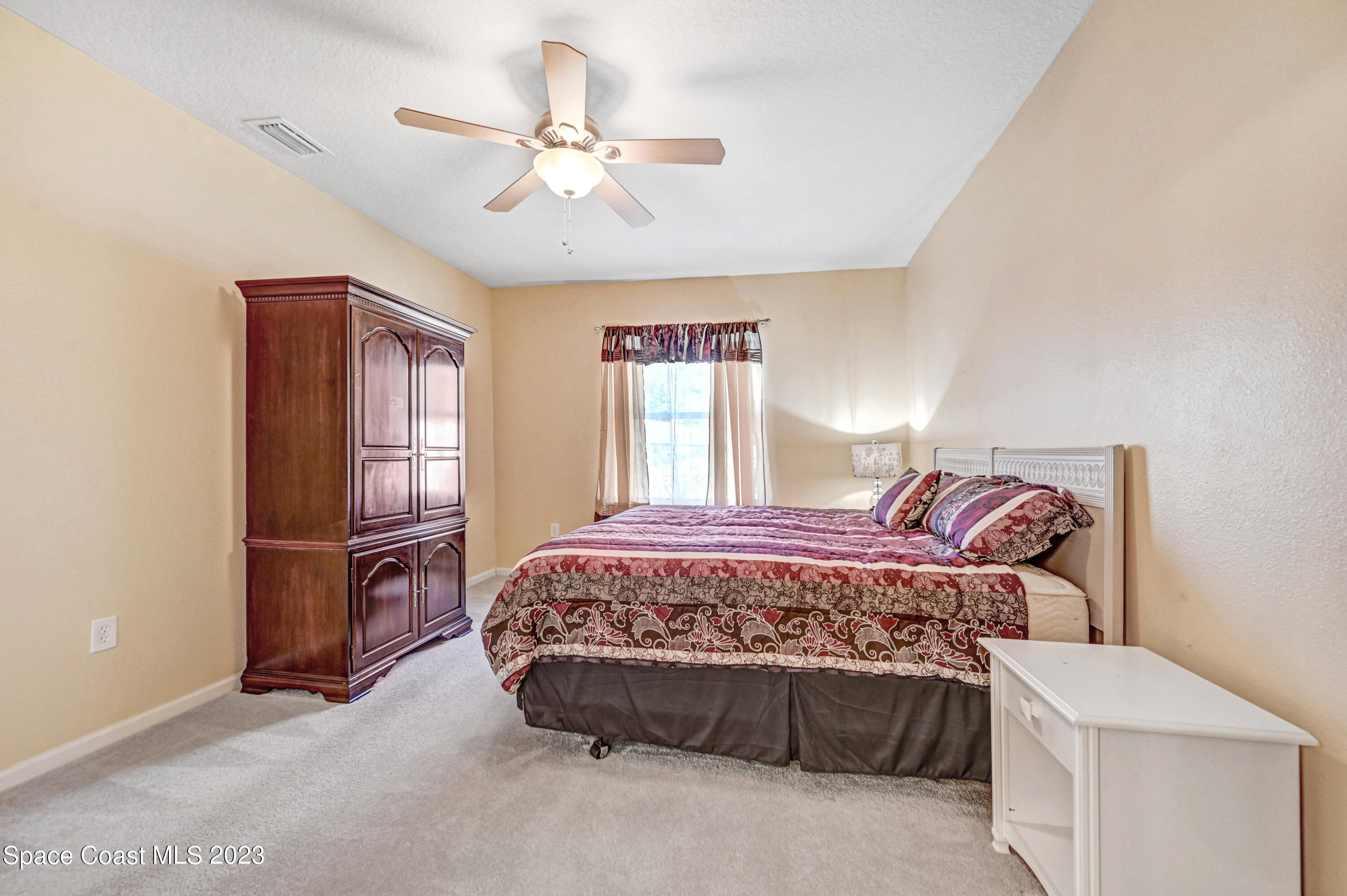 6720 Cairo Road Port St. John, FL 32927 - Photo 33 of 38 a bedroom with a bed and window