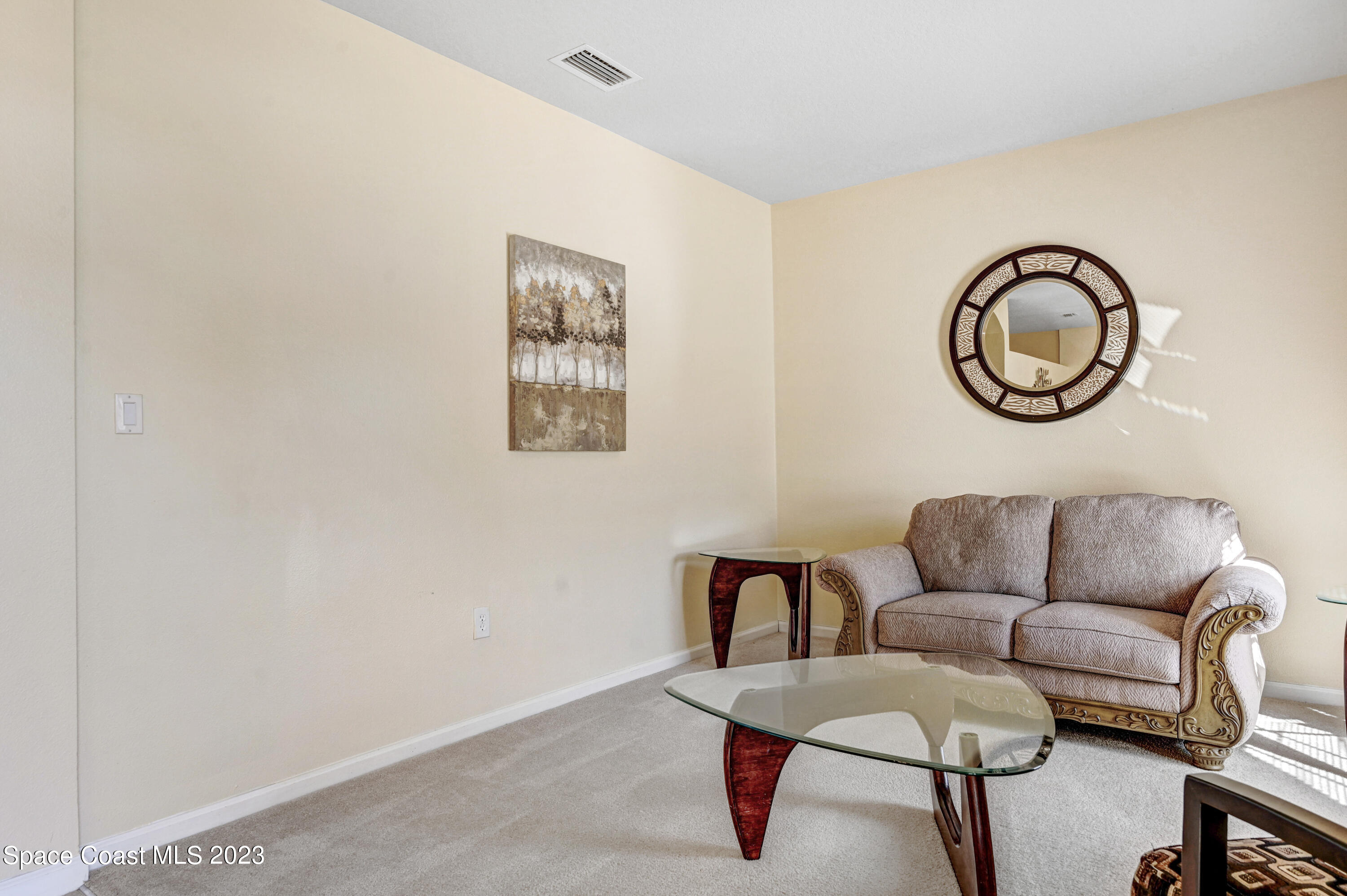 6720 Cairo Road Port St. John, FL 32927 - Photo 38 of 38 a living room with furniture and a blue wall