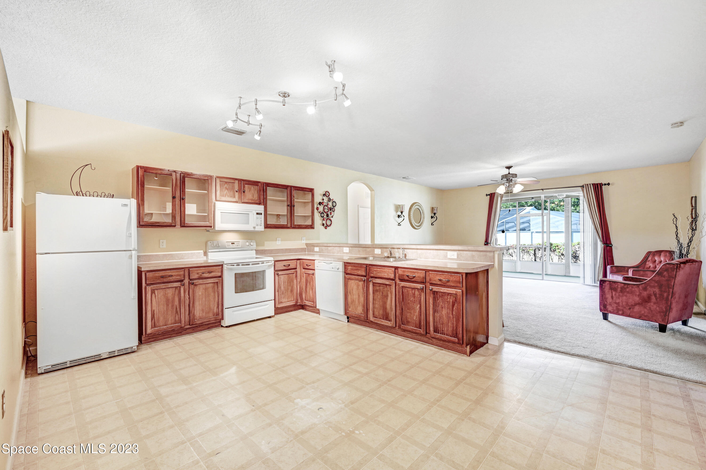 6720 Cairo Road Port St. John, FL 32927 - Photo 6 of 38 a kitchen with stainless steel appliances a sink counter top space and cabinets