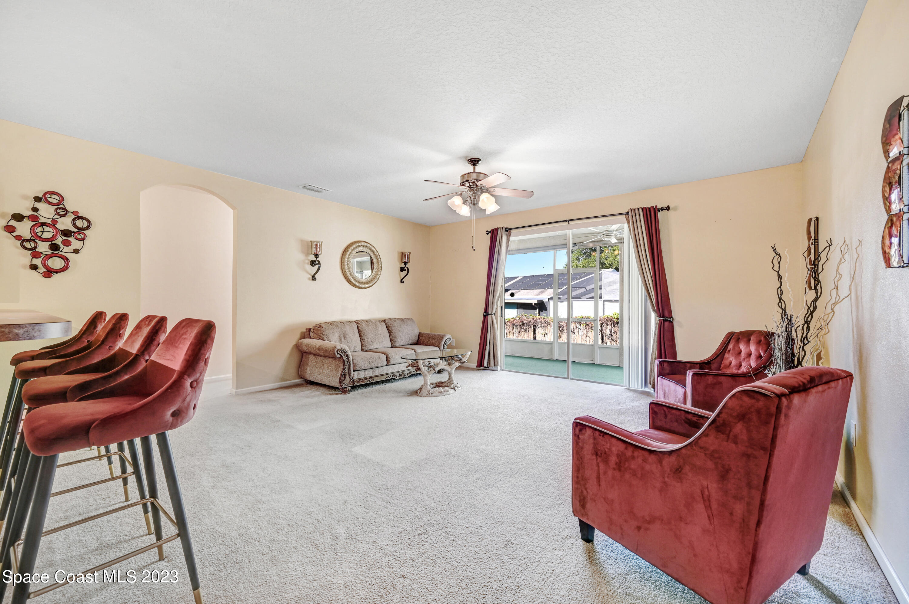 6720 Cairo Road Port St. John, FL 32927 - Photo 9 of 38 a living room with furniture and a large window