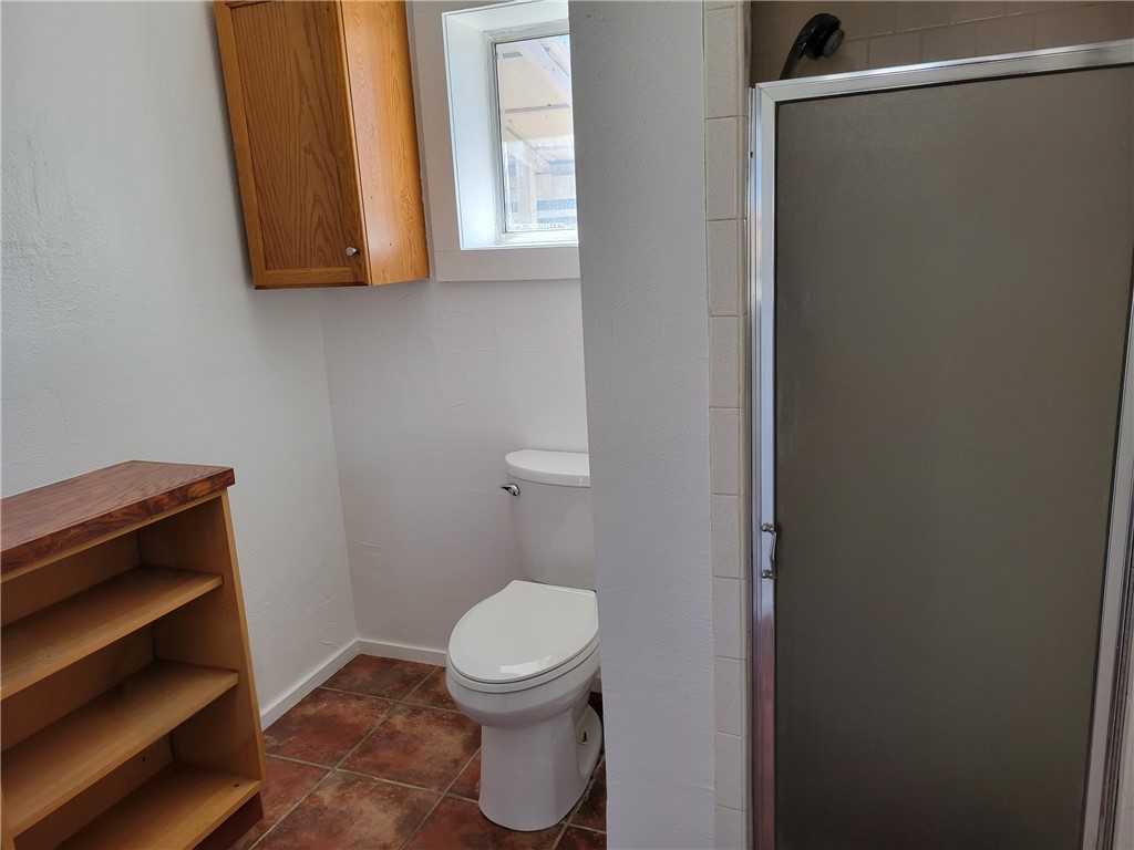415 8th Street Bandera, TX 78003 - Photo 11 of 13 a bathroom with a toilet and a window