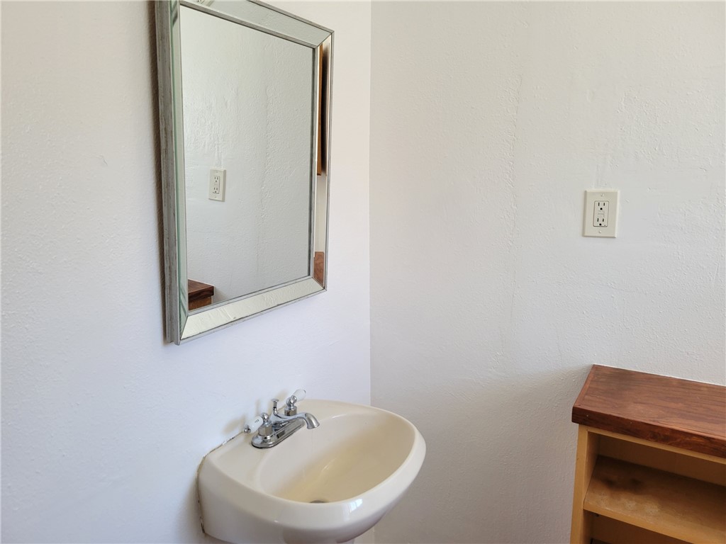415 8th Street Bandera, TX 78003 - Photo 12 of 13 a bathroom with a sink and a mirror