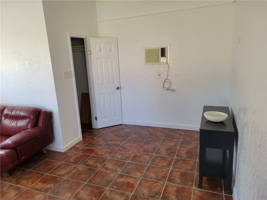 415 8th Street Bandera, TX 78003 - Photo 7 of 13 a view of a livingroom with wooden floor and bathroom