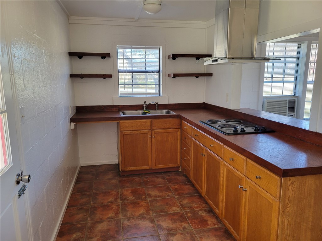 415 8th Street Bandera, TX 78003 - Photo 9 of 13 a kitchen with stainless steel appliances granite countertop a sink stove and cabinets