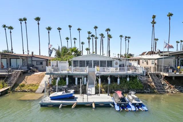 a front view of a house with swimming pool having outdoor seating
