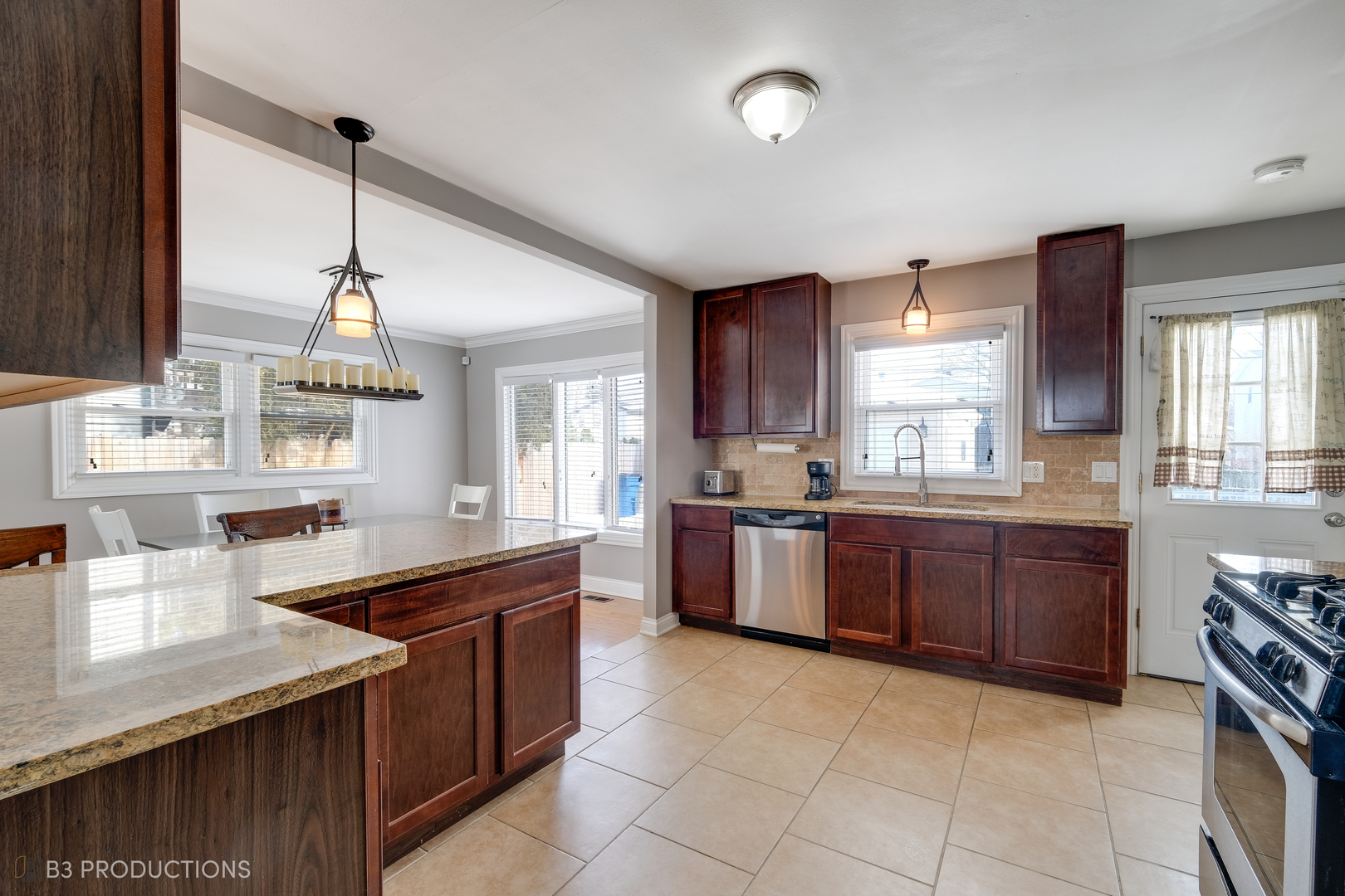 1415 South Chestnut Drive Mount Prospect, IL 60056 - Photo 5 of 15 a kitchen with stainless steel appliances granite countertop a sink counter space cabinets and a window