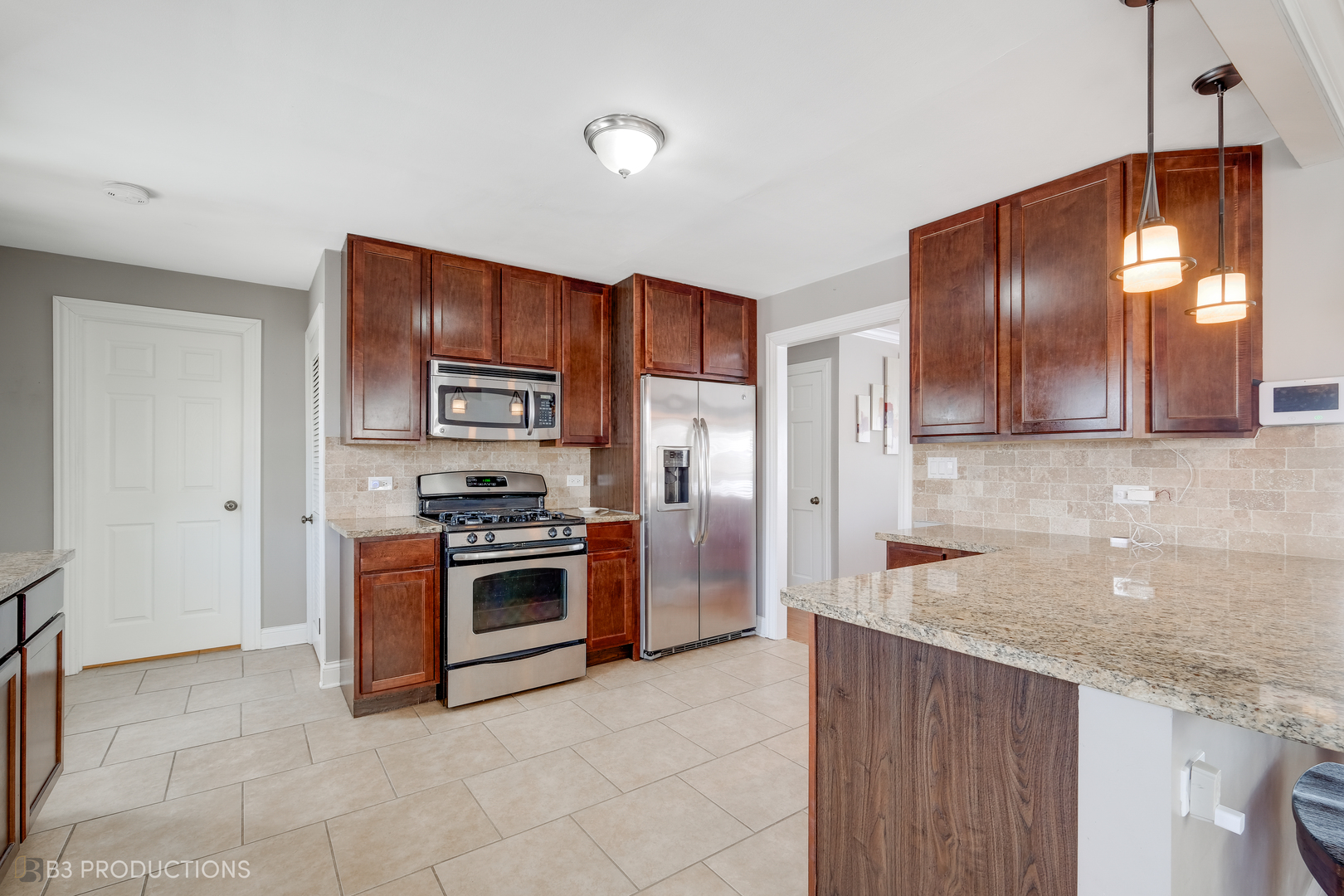 1415 South Chestnut Drive Mount Prospect, IL 60056 - Photo 6 of 15 a kitchen with stainless steel appliances granite countertop a stove and a sink